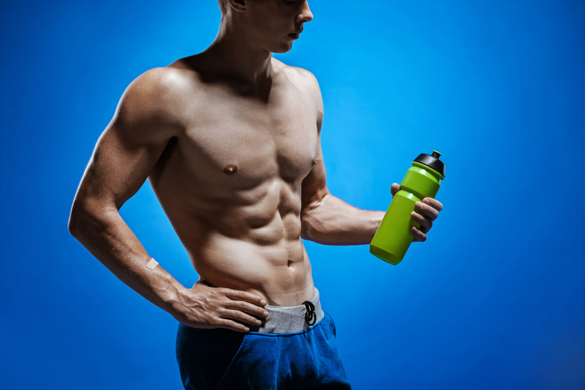 fit young man with beautiful torso blue background