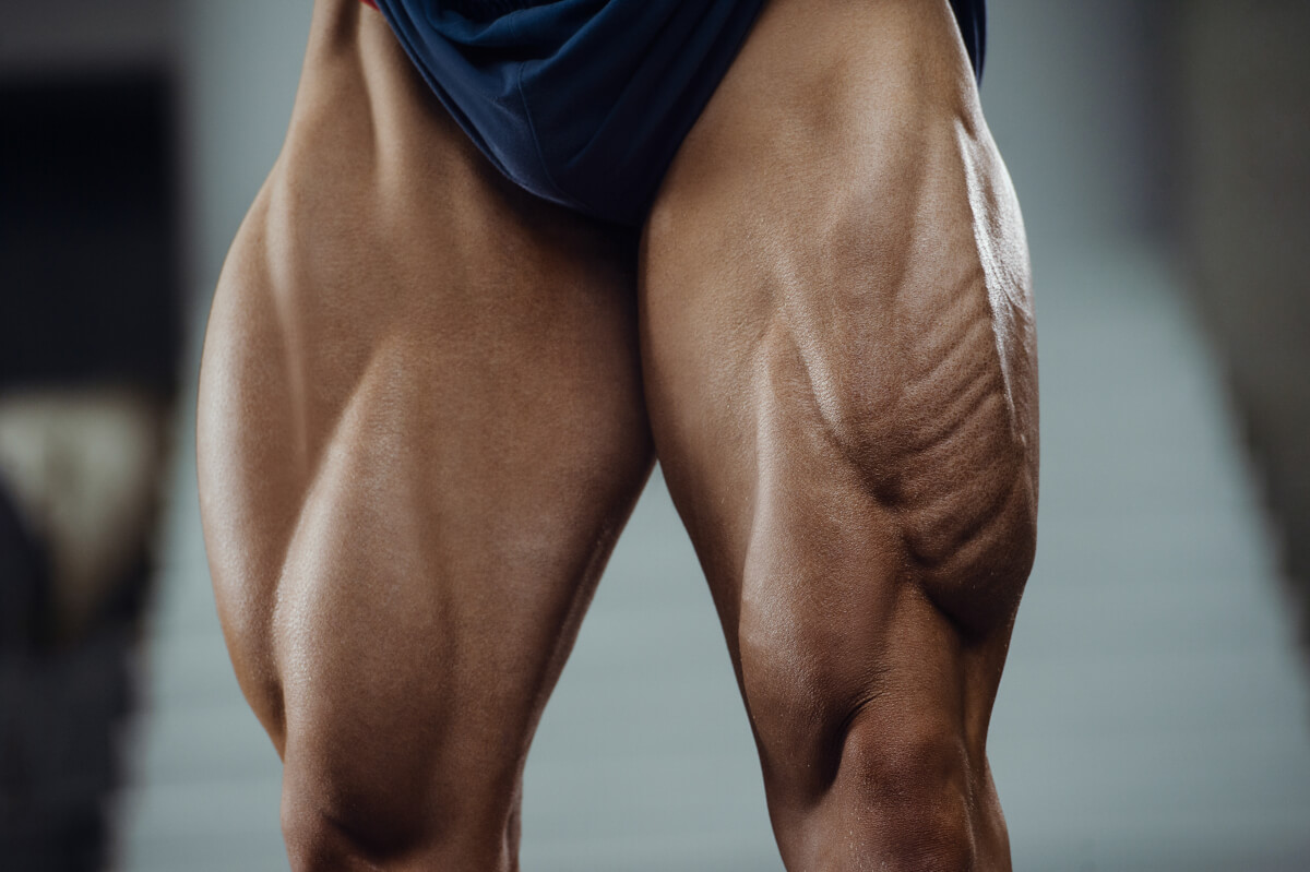 caucasian power athletic man training pumping up leg quadriceps muscles