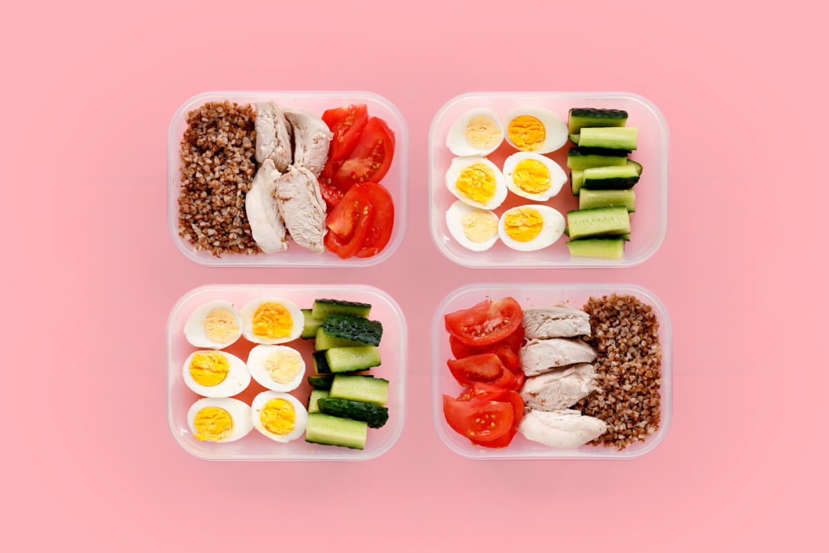 healthy fitness food whole day multiple portions containers pink background