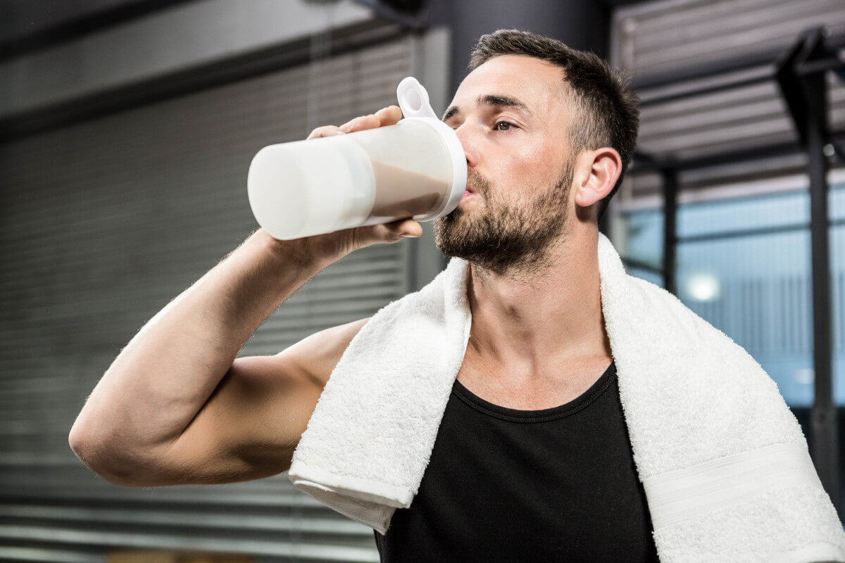 muscular man drinking protein shake crossfit gym 1