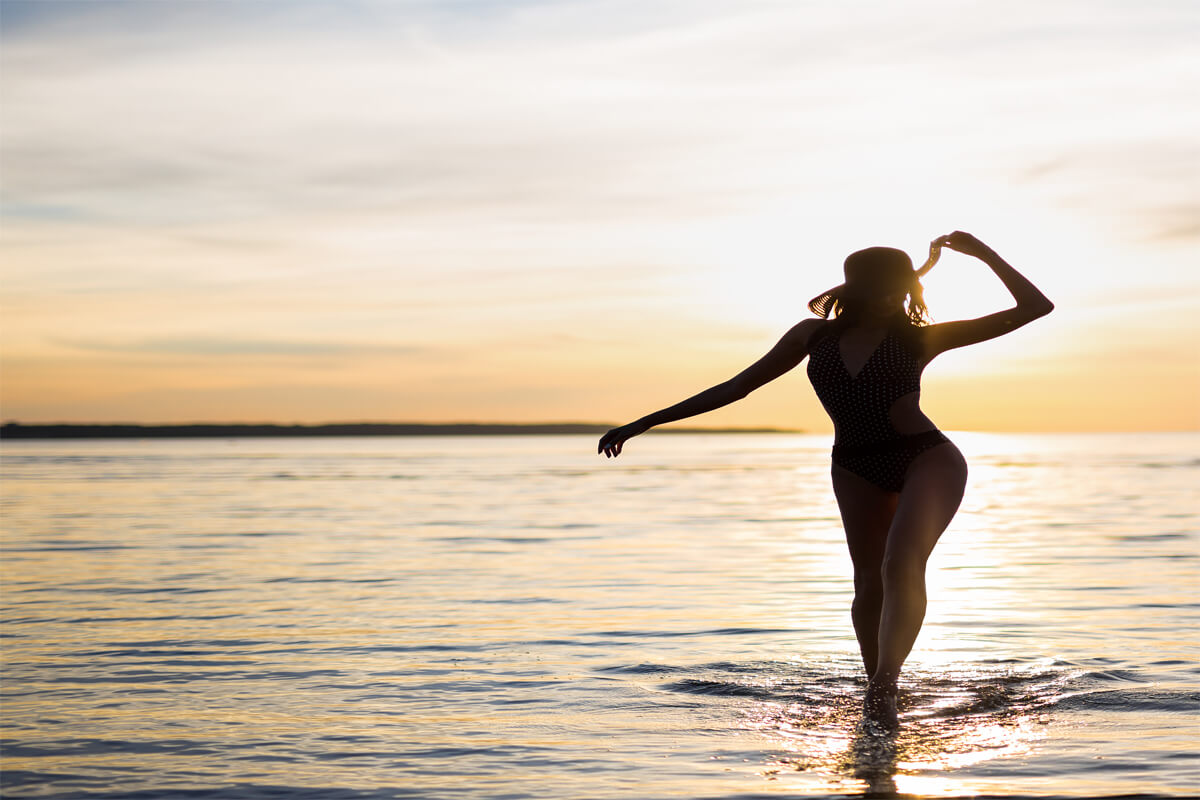 silhouette young sexy woman bikini walking beach sunset