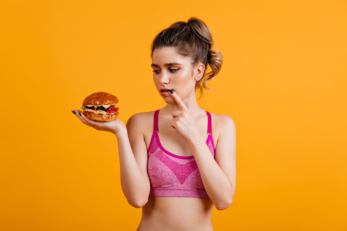 woman hesitate eat burger