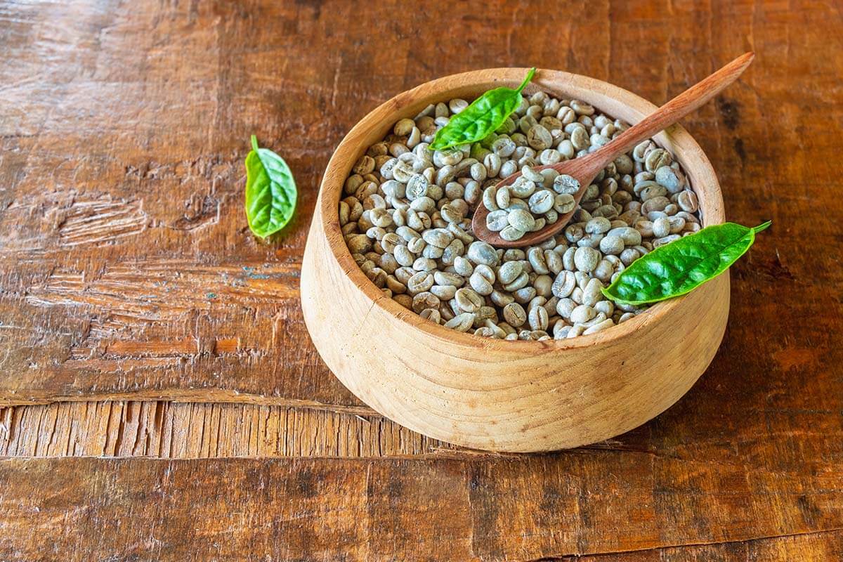 unroasted green coffee beans wooden bowl