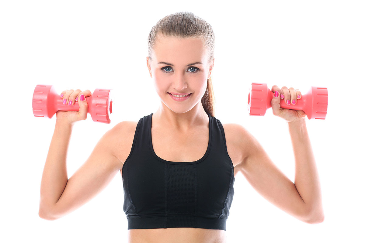 happy woman doing exercises with dumbbells